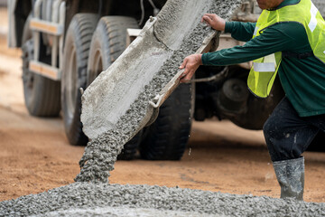 Construction worker pouring concrete from truck © Rassarin
