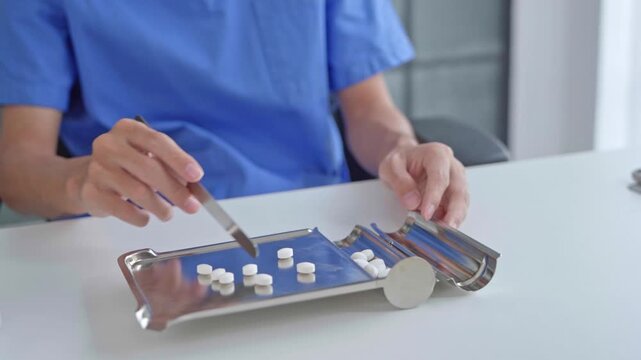 Pharmacist using equipment to dispense medication