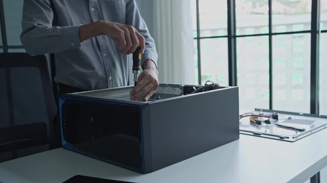 Asian IT engineer using screwdriver fix pc case