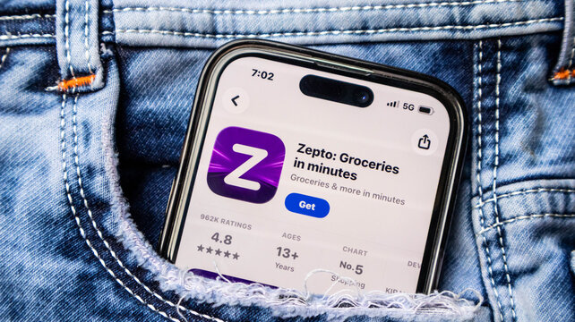 Smartphone displaying zepto grocery shopping app on screen in jeans pocket