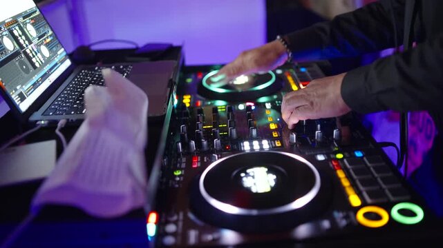 DJ Mixing Live On A Digital Controller during wedding reception In Club And Close-Up Hands