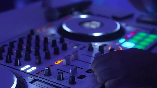 DJ Mixing Live On A Digital Controller during wedding reception In Club And Close-Up Hands
