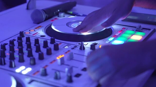 DJ Mixing Live On A Digital Controller during wedding reception In Club And Close-Up Hands