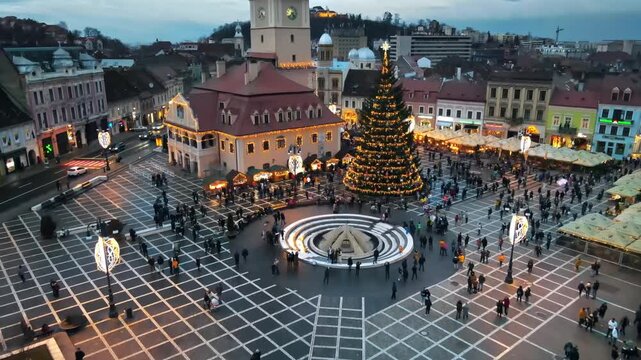 Aerial view of festive christmas market in Council Square of Brasov Romania at twilight.