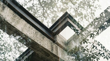 Obraz premium Double exposure of tree leaves and branches superimposed on concrete and steel architectural structure