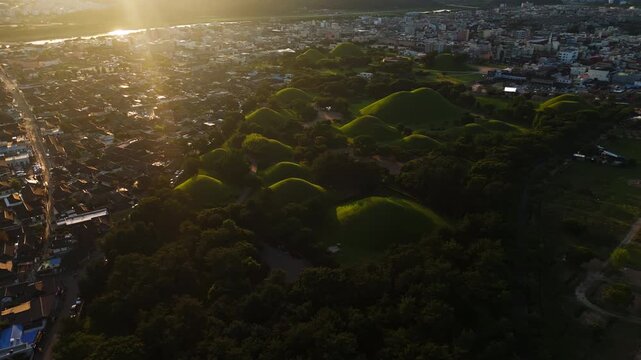 Aerial panorama of Historical Mound Graves Surrounded by Gyeongju City, sunset