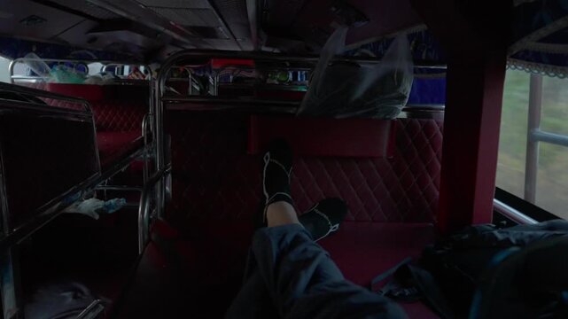 POV shot on a sleeper bus travelling through Laos, at full stretch on the tiny beds provided.