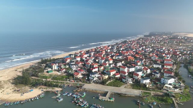 Nam Trach, Quang Binh (Quang Tri), Vietnam &ndash; 4K aerial drone footage of river mouth, East Sea, sandy beach, fishing village, boats, beachfront roads and seaside landscape near Dong Hoi City