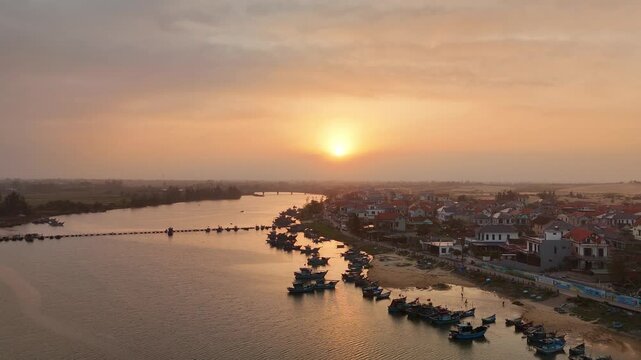 Sunset over Nam Trach and Hoan Lao, Quang Binh (Quang Tri), Central Vietnam&ndash; 4K aerial drone footage of river mouth, East Sea, sandy beach, fishing village, boats, beachfront roads, seaside landscape