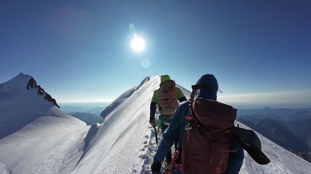 POV mountaineering in rope team with mountaineers on the ridge of summit Parrotspitze and glacier panorama with helicopter approaching mountain hut Margherita Hut on Signalkuppe in Pennine Alps, Italy