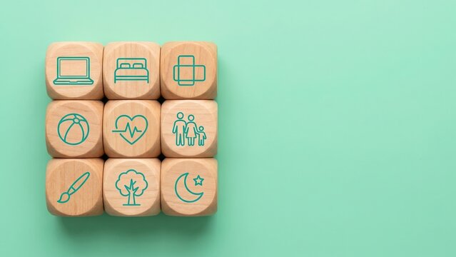 Conceptual image of wooden cubes featuring health and lifestyle symbols illustrating self care time management and daily habits.