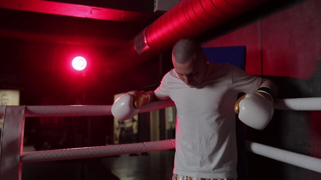 Exhausted boxer resting between rounds in the ring