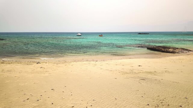 People enjoying a sunny day at Caleta del Congrio beach in Lanzarote