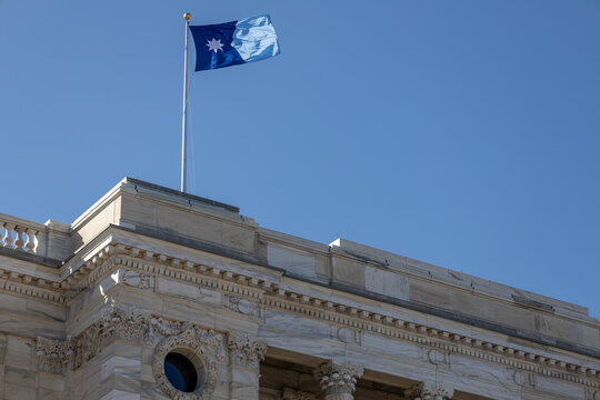 View of the current flag of the state of Minnesota, flying above the State of Minnesota Capitol building roof