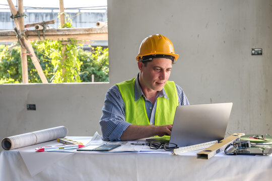 Caucasian architect man concentrate working on computer laptop in construction site work space