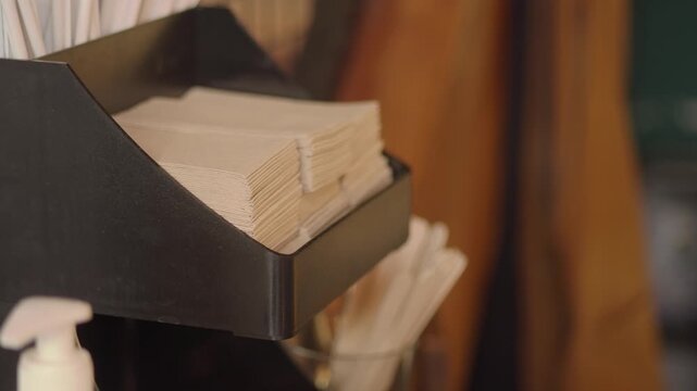 Napkins and straws on display at a cafe counter