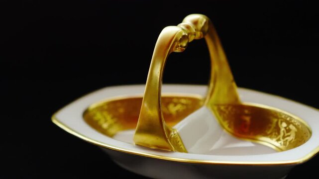 Luxurious gold plated tableware sits isolated on a black background, symbolizing wealth, status, and refined taste. Perfect for premium product ads, luxury branding, and elegant visual storytelling.