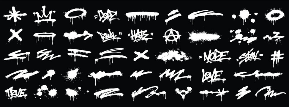 Set of graffiti spray paint elements, tags, drips, and splatters on black background