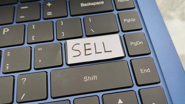 Closeup of finger press, push or click key with sell word lettering written on laptop computer keyboard. Stock market, share trading, ecommerce business, online selling or quick commerce sales concept