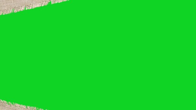 Torn canvas fabric texture material revealing animated on a green screen chroma key background. It gives a high quality professional template design element for video compositing motion