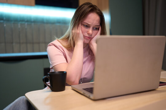 Mental overload at laptop in modern kitchen interior