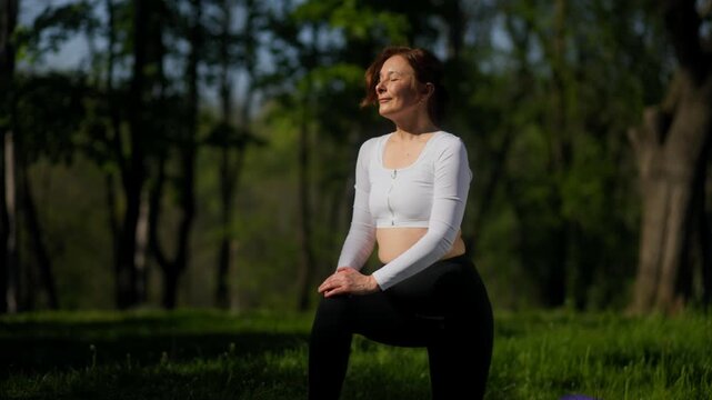 Profile of 45 year old female doing lunge stretch in outdoor fitness