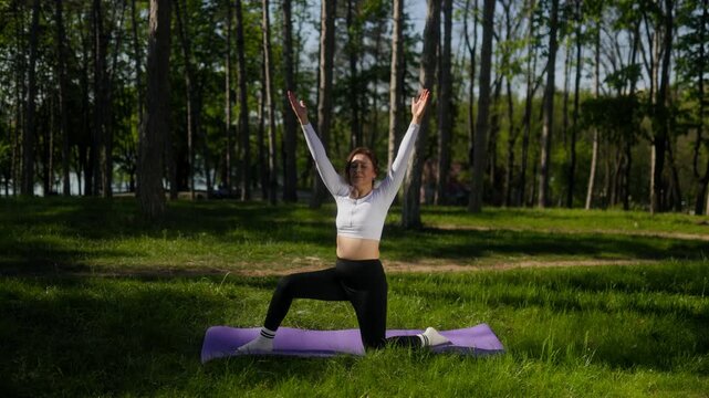 Close up 45 year old woman stretching quadriceps in sunny green park