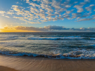 Fototapeta premium Sunrise at the Seaside with a Mackeral Sky