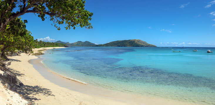 Paradisiacal white sand beach, turquoise waters and vibrant coral reefs of Nacula Island, Yasawa Island Group, Fiji