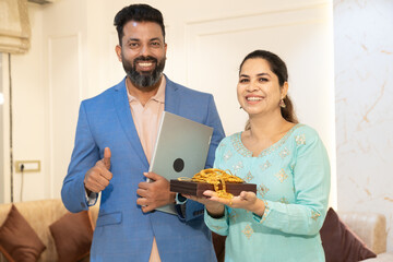 Indian woman holding gold jewellerystanding with bank executive or financial agent for secure...