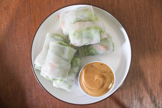 Top view of fresh Vietnamese spring rolls with peanut dipping sauce