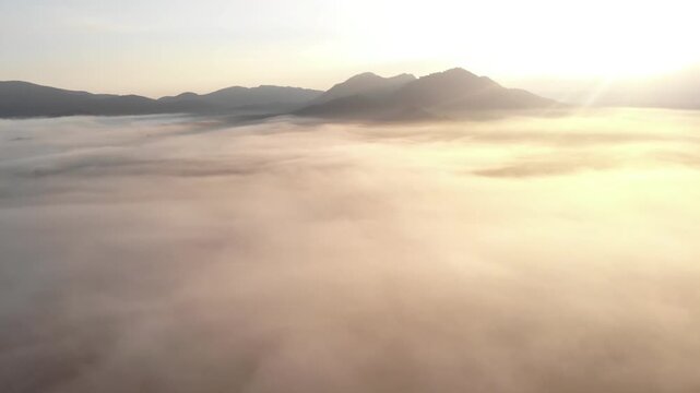 Beautiful scene view of misty in the morning with the mountain, farm, small village and forest at sunrise time in Loei province, Thailand.