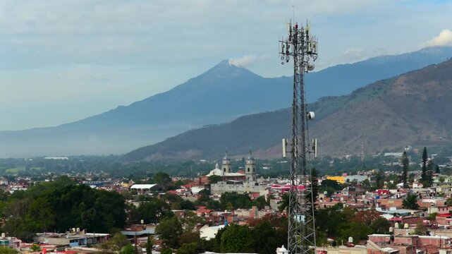 Tuxpan, Jalisco, Mexico with the Nevado de Colima Volcano in the distance, aerial view