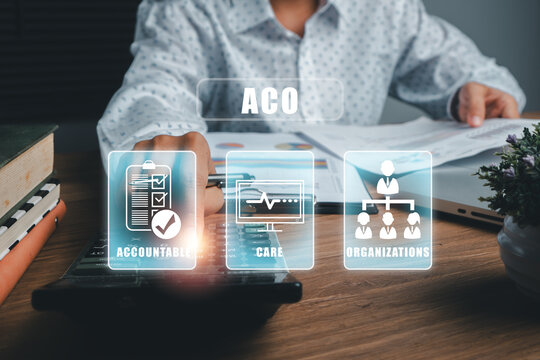 Business professional using calculator with ACO concept hologram, emphasizing accountability, care, and organization.