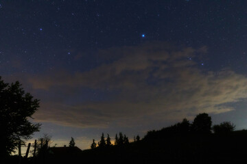 Fototapeta premium Constellations, landscape, Milky Way stars on a dark countryside skies.