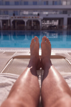 Man enjoying the hot summer at swimming-pool.