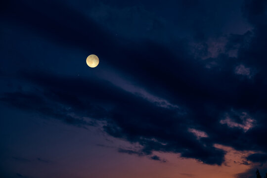 Full Moon on a twilight background.