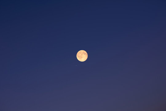 Full Moon on a twilight background.