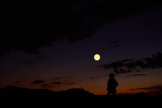 Woman observing stars, planets, Moon and other celestial objects.