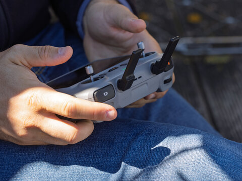 A pilot steadies a compact drone controller