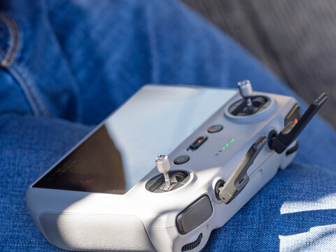 A pilot steadies a compact drone controller