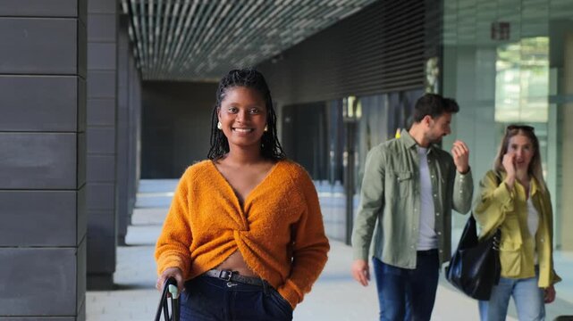 Joyful young woman strolling forward with her friends, showcasing happiness and connection during their enjoyable outing together in a lively atmosphere filled with excitement and laughter.