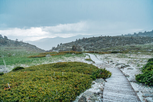 Snowfall over mountain trail in Pe&ntilde;alara natural park