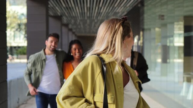 A young woman happily walking with her friends while holding a stylish handbag, showcasing friendship and joy in a lively atmosphere filled with excitement and youthful energy.