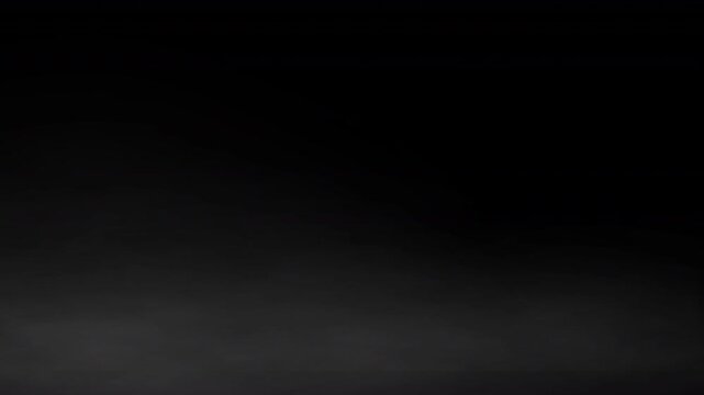 low lying dry ice concert fog or early low lying mist or fog effect or ambient cinematic  horror white wispy ground smoke special effect overlay 4K animation with plain black background