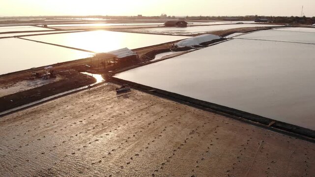 Aerial view of salt harvesting ponds over coastal Thailand, crystal salt ponds.
