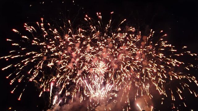 Vibrant fireworks exploding in the night sky with colorful lights and smoke