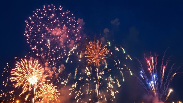 Vibrant fireworks exploding in the night sky with colorful bursts of light and smoke