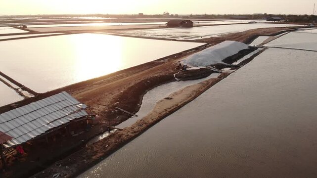 Aerial view of salt harvesting ponds over coastal Thailand, crystal salt ponds.