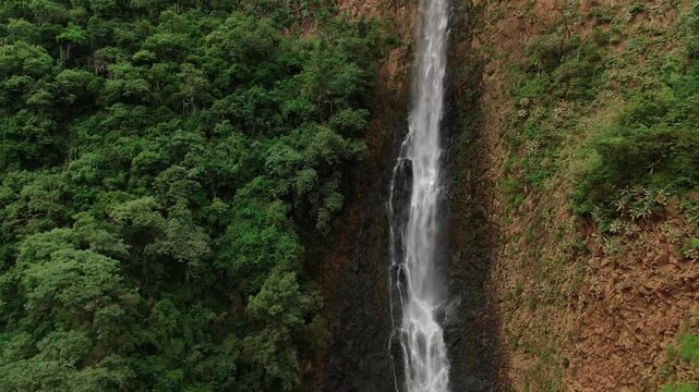 Scenic View Of Cascada el Salto del Nogal Over Sheer Cliffs Near Tapalpa In Jalisco, Mexico. Aerial Pullback Shot